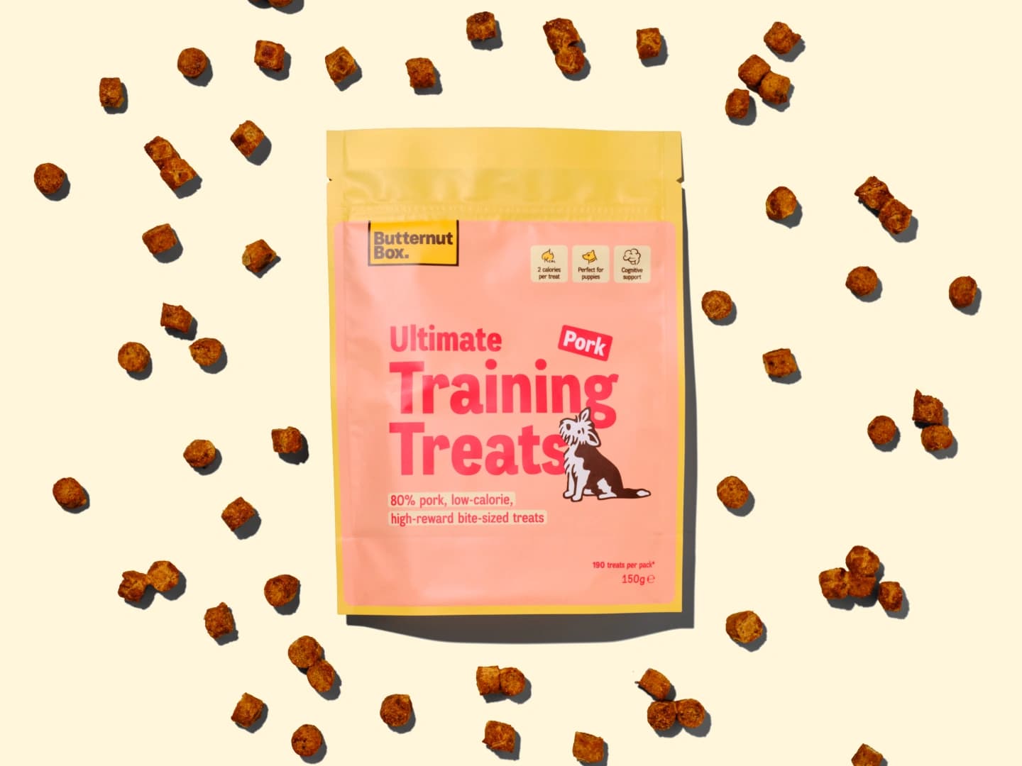 Butternut Box Ultimate Training Treats for dogs in pork flavor, with scattered small treat pieces around the package.