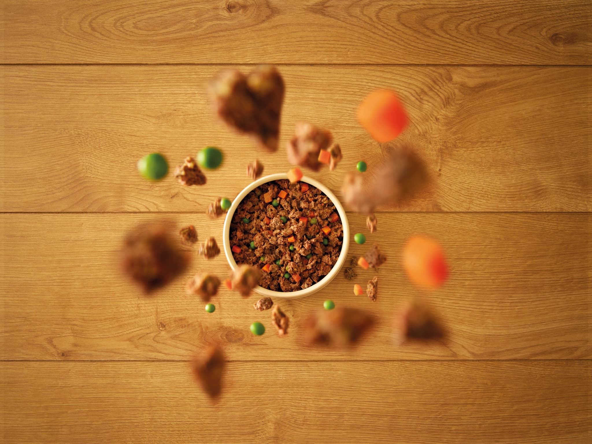 Ingredients falling into bowl of food